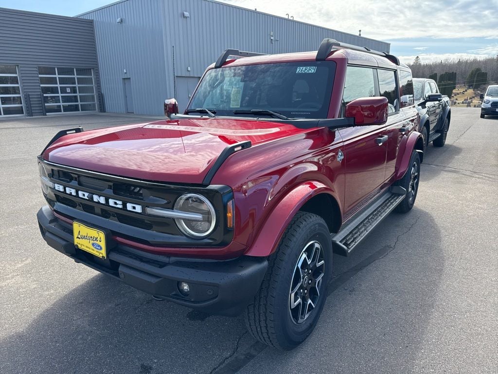 2026 Ford Bronco Outer Banks in Ruby Red Metallic Tinted Clearcoat — front three-quarter view